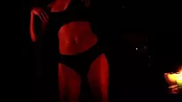 she dances in the dark, slowly removing her panties