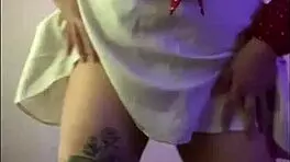Young 18+ wife with tattoo touches herself with vibrator in homemade scene, focusing on big tits and ass