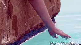hottie strips naked by the pool, teasing her hairless pussy and skinny body for erotic seduction