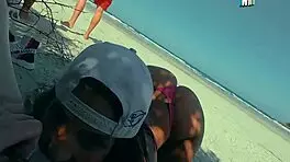 Friends Engage in Intimate Activities on Crowded Beach