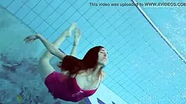 Anna netrebko teases in bikini while swimming in the pool, showing off her petite figure.