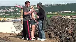 A young blonde cutie gets fucked hard in the street by two guys in a public threesome