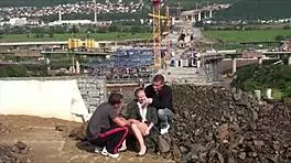 A young blonde cutie gets fucked hard in the street by two guys in a public threesome