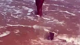 Young African Woman Flashes On The Beach