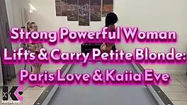 strong powerful woman lifts and carries petite blonde