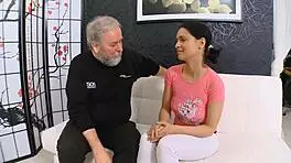 in the dimly lit room, the old man's large shaft slowly enters the young girl's tight aperture, causing her to moan loudly as he thrusts deeper into her wet pussy