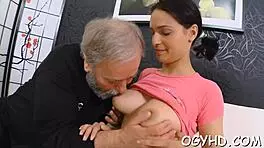 in the dimly lit room, the old man's large shaft slowly enters the young girl's tight aperture, causing her to moan loudly as he thrusts deeper into her wet pussy