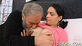 in the dimly lit room, the old man's large shaft slowly enters the young girl's tight aperture, causing her to moan loudly as he thrusts deeper into her wet pussy