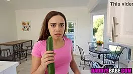 Young girl sucks cucumber before blowing older man