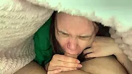 Young brunette climbs under blanket for deep blowjob in bedroom 😊
