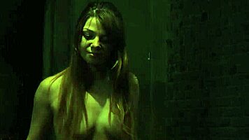 in the dungeon, a mistress whips and humiliates her bound submissive teen companion