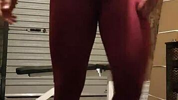 Muscular blonde milf teases in gym, undressing leggings for striptease