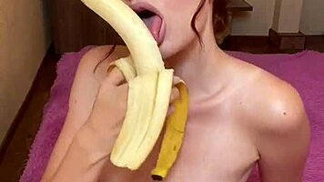 Hot brunette enjoys sucking banana