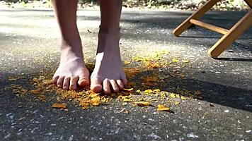 Teen brunette giggles as her feet get wet at the beach on beat2feetcom.