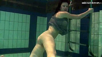 Katya Okuneva is at the pool, bouncing her tits in a dress and bikini