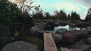 Sexy brunette fingering her pussy outdoors at the resort.
