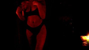 she dances in the dark, slowly removing her panties