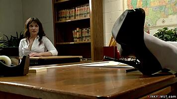 busty milf professor guides student in classroom activity