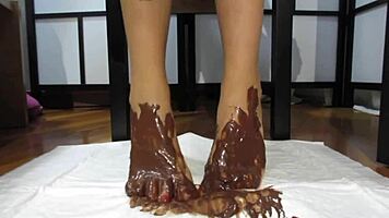 My feet with varnished nails covered in chocolate cream