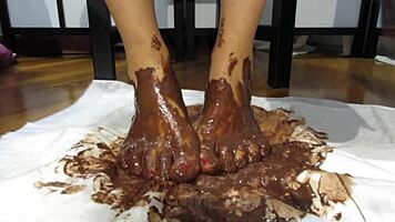 My feet with varnished nails covered in chocolate cream