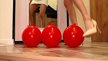 brunette amateur crushes balloons with heels in miniskirt