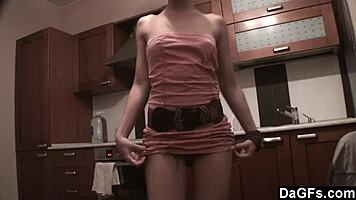 Dagfs - freckled-face babe plays with her dildo on kitchen counter, ripping clothes and exposing small 18+ tits and shaved pussy.