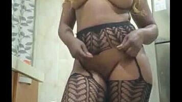 beautiful african girl shows off her perfect body in miniskirt and stockings