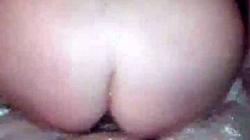 Sexy milf aggressively fucks her young boyfriend in the hot tub, showing off her big tits and ass.