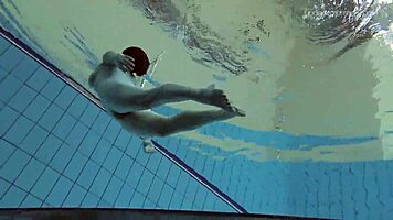 Lada Poleshuk bathes hot in pool, wet and underwater.