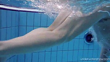 Roxalana swims in pool exposing tight pussy