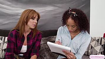 Redhead lesbian babe licks ebony girlfriend's pussy in scissoring session