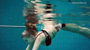 Dashka enjoys a beautiful swim in the pool, going from bikini to naked underwater.