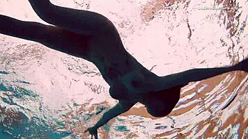 Dashka enjoys a beautiful swim in the pool, going from bikini to naked underwater.