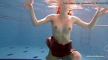 big tits brunette mia strips naked underwater in the pool, showing off her shaved body