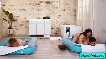 Sexy big beautiful busty masseuse handles two young 18+ boys in steamy nuru massage session.