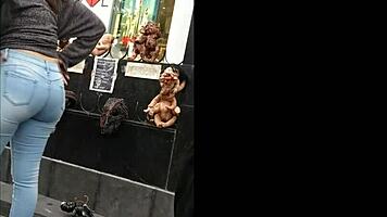 teen latina with tight jeans showing off her curves in a voyeur scene