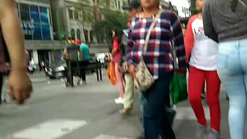 teen latina with tight jeans showing off her curves in a voyeur scene