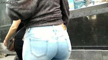 teen latina with tight jeans showing off her curves in a voyeur scene