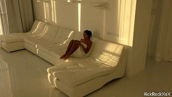 The black asian teen rides the red cock in the white room.