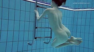 Anna netrebko teases in bikini while swimming in the pool, showing off her petite figure.