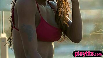 Petite ebony milf feels the thrill of stripping in the pool to show her juicy round tits.