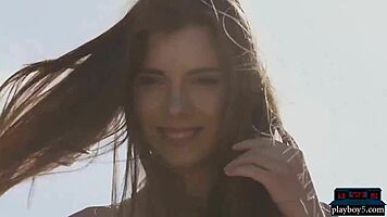 Petite Russian centerfold Kate Chromia strips outdoors, ripping clothes to reveal hairy pussy and tits.