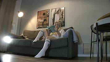 Busty milf casually strips panties on couch while reading