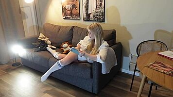 Busty milf casually strips panties on couch while reading