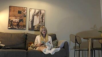 Busty milf casually strips panties on couch while reading