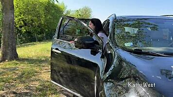Crazy girl pees on the car roof to clean the windshield.
