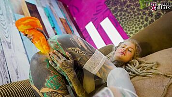 Tattoo girl feels pleasure in solo anal play with big dildo in sexy fishnets