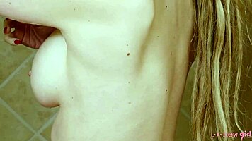 charming blonde girl enjoys a hot shower