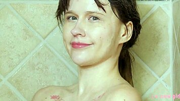 charming blonde girl enjoys a hot shower