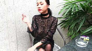 Young girl smokes topless in leather skirt